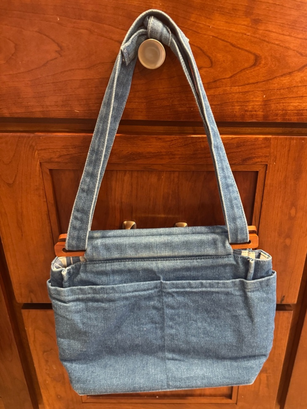 Denim lined handmade bag.Straps adjustable.Pockets inside&out. Wooden accents